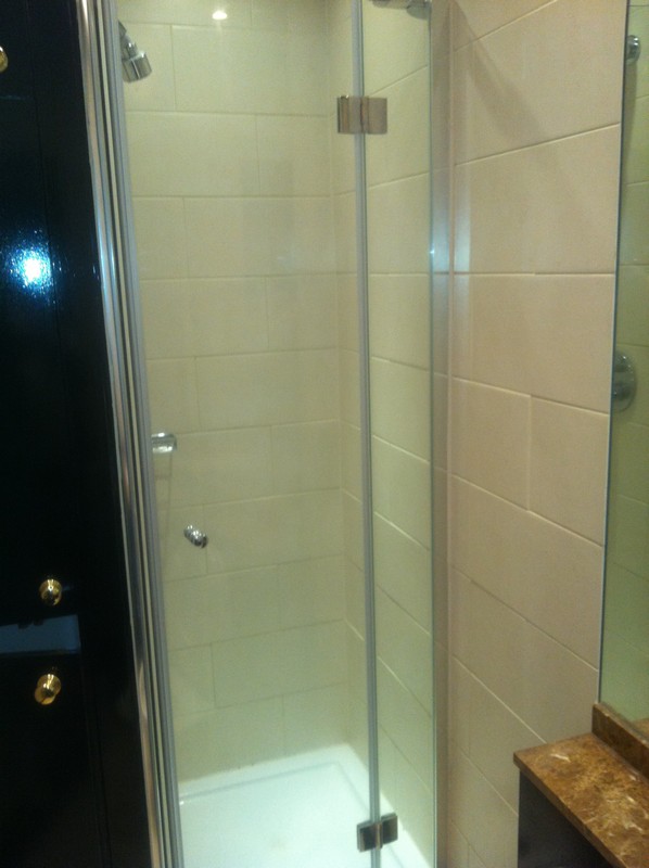 Frameless glass shower enclosure with chrome fittings in Parson's Green
