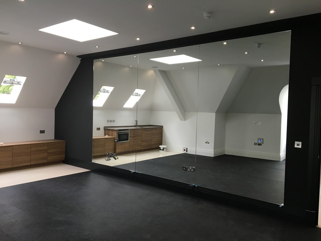 Frameless glass wall dividing loft conversion in Parson's Green