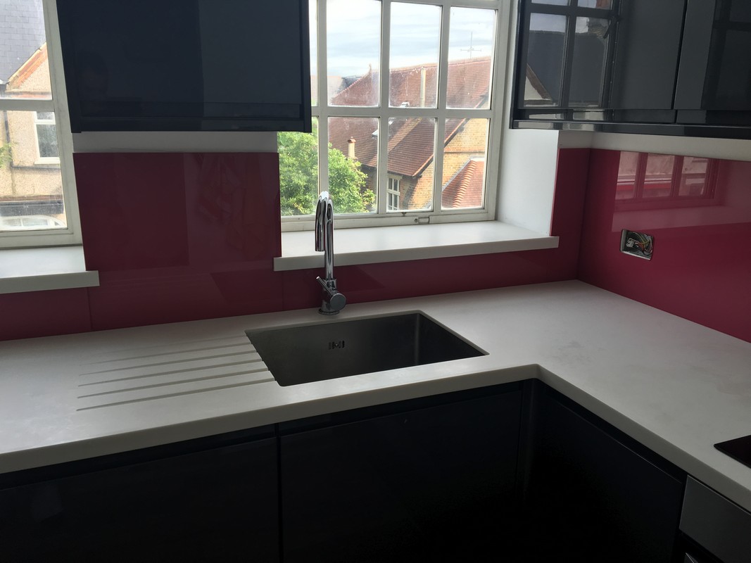 Deep plum coloured glass splashback in modern Parson's Green kitchen