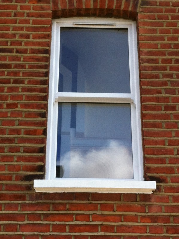 uPVC sash window on Victorian red brick house in Parson's Green
